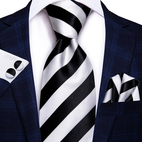 Black and white striped silk tie displayed on a suit