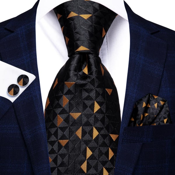 Black gold pyramid silk tie displayed on a suit