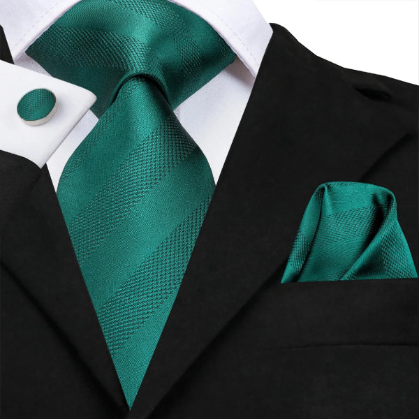 Jade green striped silk tie set on a suit