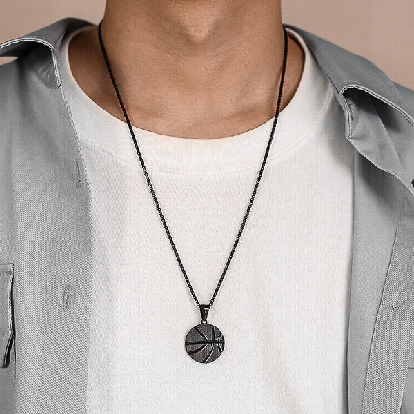 Man wearing a black basketball pendant necklace