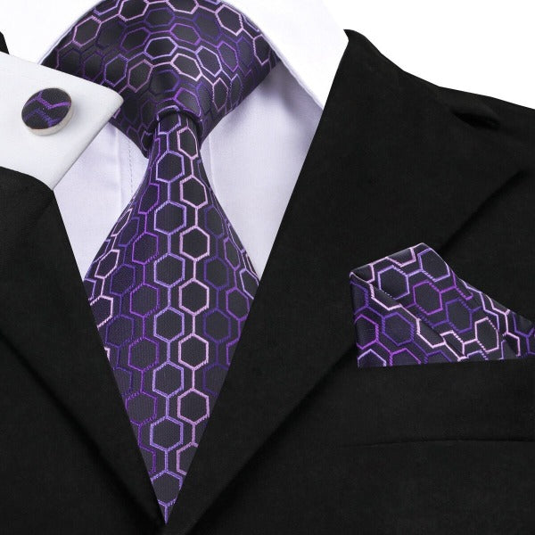 Man wearing a purple hexagon silk tie set with matching pocket square and cufflinks