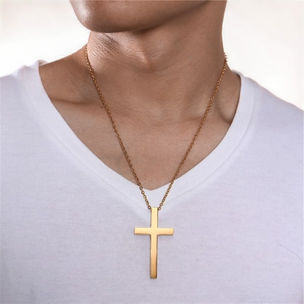 Man wearing a large gold cross pendant necklace