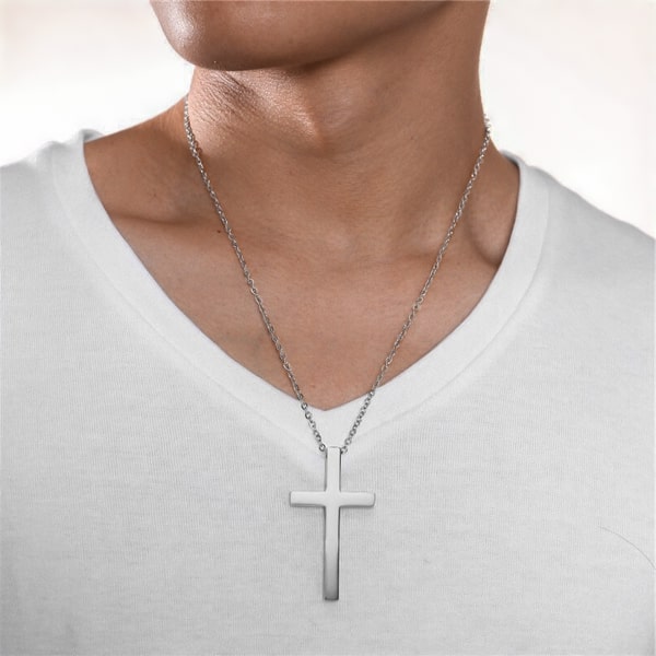 Man wearing a large silver cross pendant necklace
