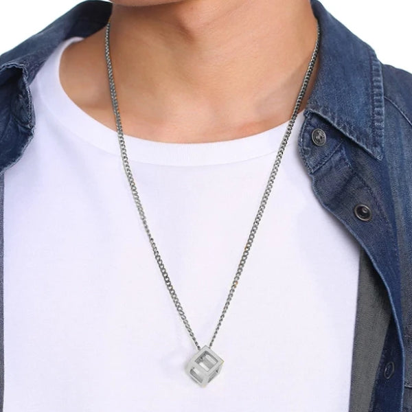Man wearing a silver cube pendant necklace for men