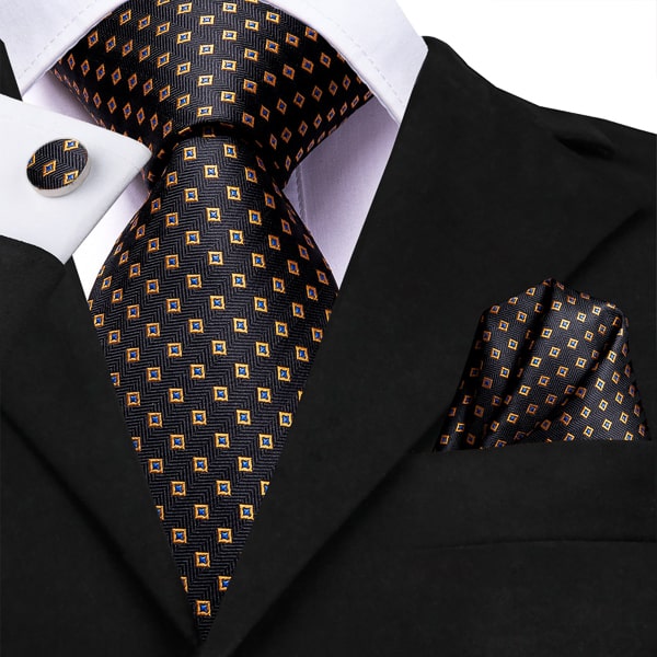 Black gold modern polka dot silk tie displayed on a suit