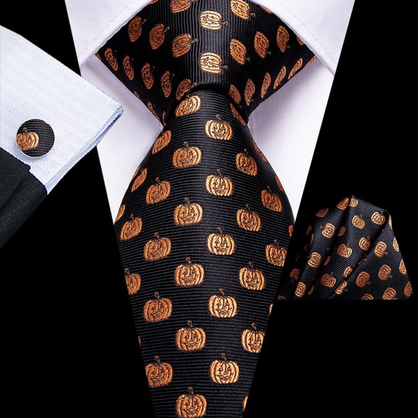 Black gold pumpkin novelty silk tie displayed on a suit