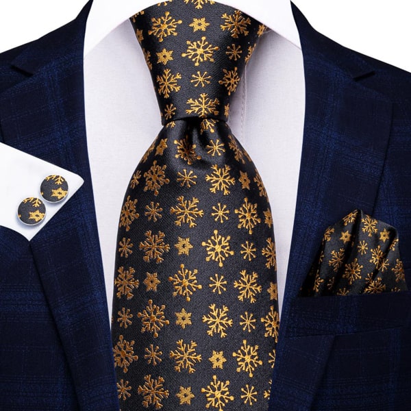 Black gold snowflake silk tie displayed on a suit