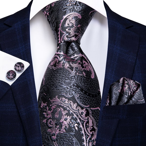 Black pink floral silk tie displayed on a suit