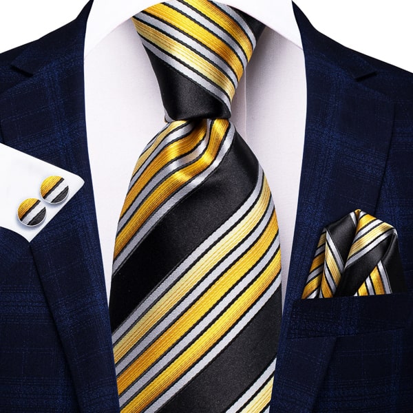 Black yellow white striped silk tie, pocket square, and cufflinks on a suit
