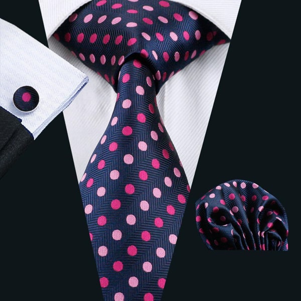 Blue pink polka dot silk tie displayed on a suit