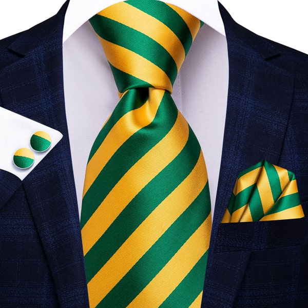 Green yellow gold striped silk tie with matching pocket square and cufflinks on a suit