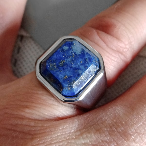 Man wearing a square blue lapis lazuli ring