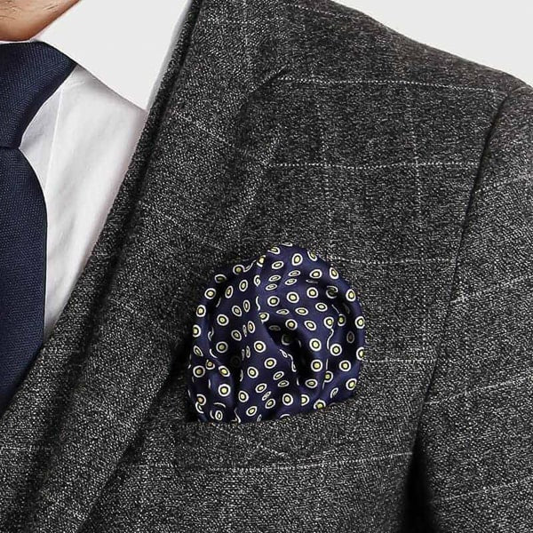 Navy blue and yellow dotted pocket square in suit jacket pocket