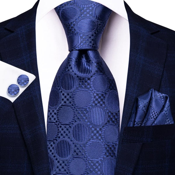 Navy blue circle silk tie displayed on a suit