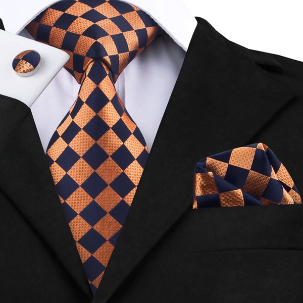 Orange black diamond silk tie displayed on a suit