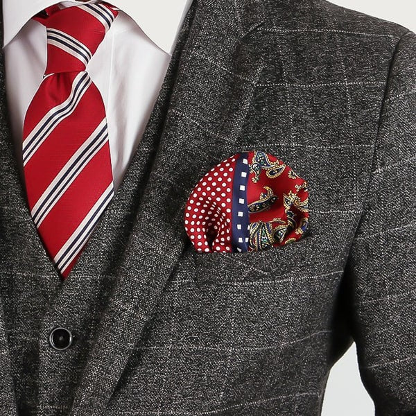 Red and navy blue multi-pattern pocket square in suit jacket pocket
