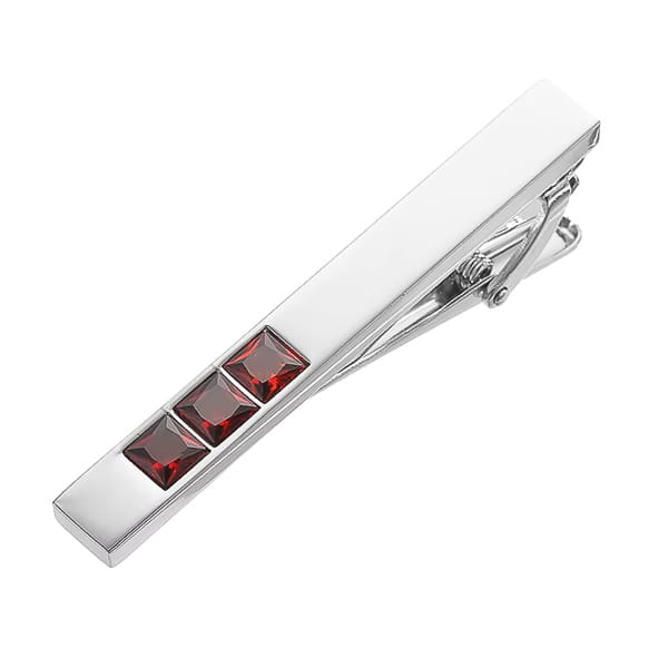 Silver tie clip with red gemstones on a white background