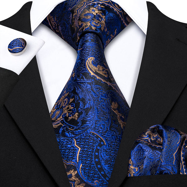 Blue gold floral tie set with a matching pocket square and cufflinks on a suit