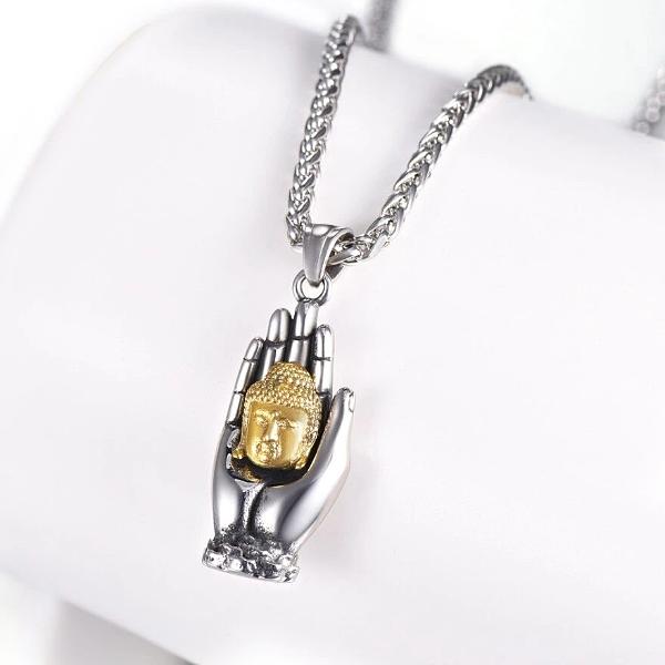 Buddha pendant necklace with gold Buddha head held by a silver hand