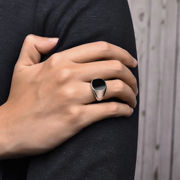 Man wearing an elegant silver ring with black stone