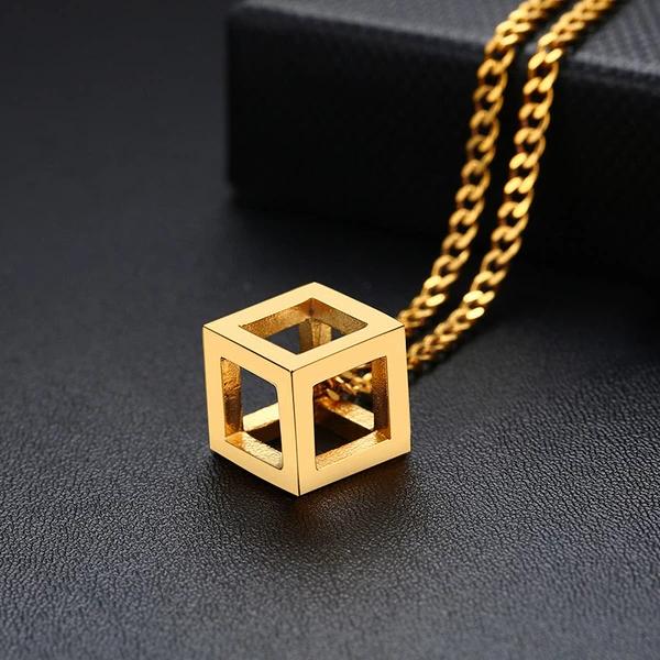 Gold cube pendant on a gold curb chain