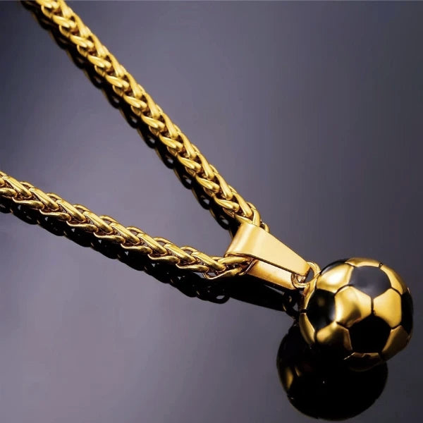 Detailed image of the gold soccer ball pendant and the gold wheat chain necklace