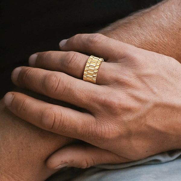 Man wearing a wide gold band ring