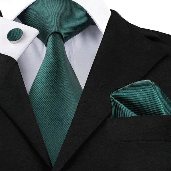 Jade green silk tie set displayed on a suit