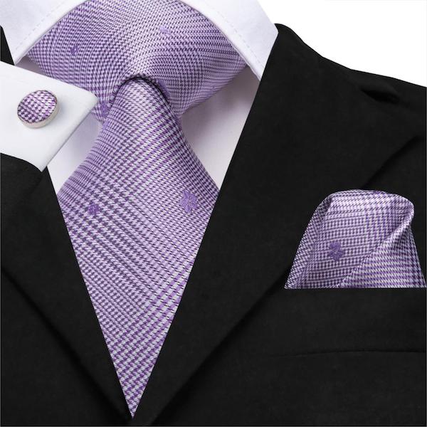 Man wearing a lavender silk tie with matching pocket square and cufflinks