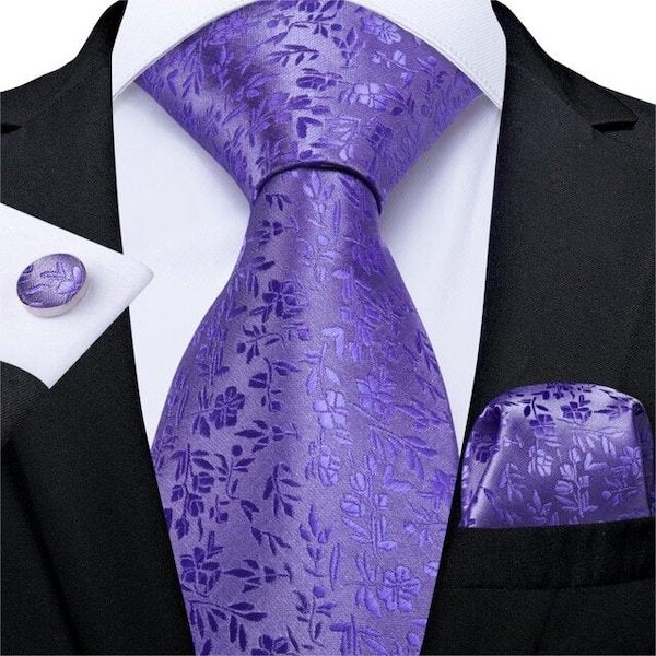 Man wearing a lilac floral silk necktie set with matching pocket square and cufflinks