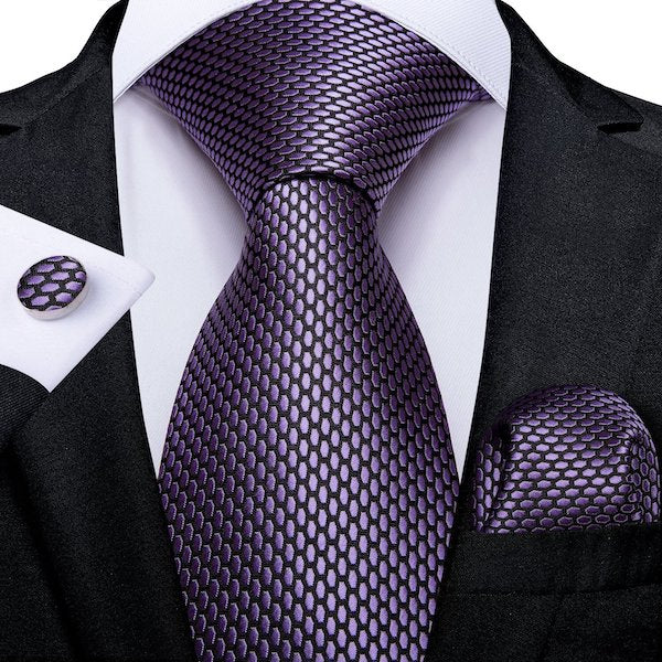 Man wearing a lilac honeycomb pattern silk tie set with matching pocket square and cufflinks