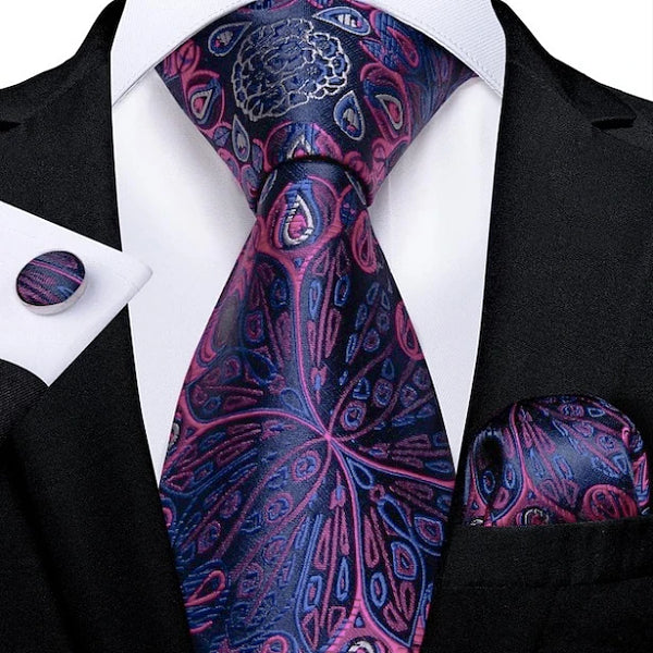 Man wearing a blue and pink peacock flower silk tie set with matching pocket square and cufflinks