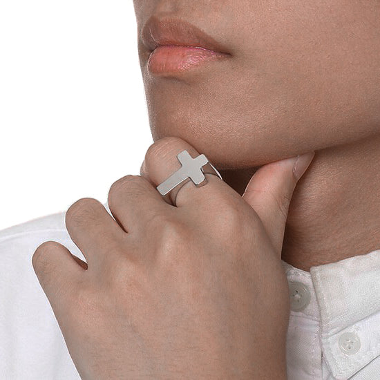 Man wearing a simple silver cross ring made of stainless steel