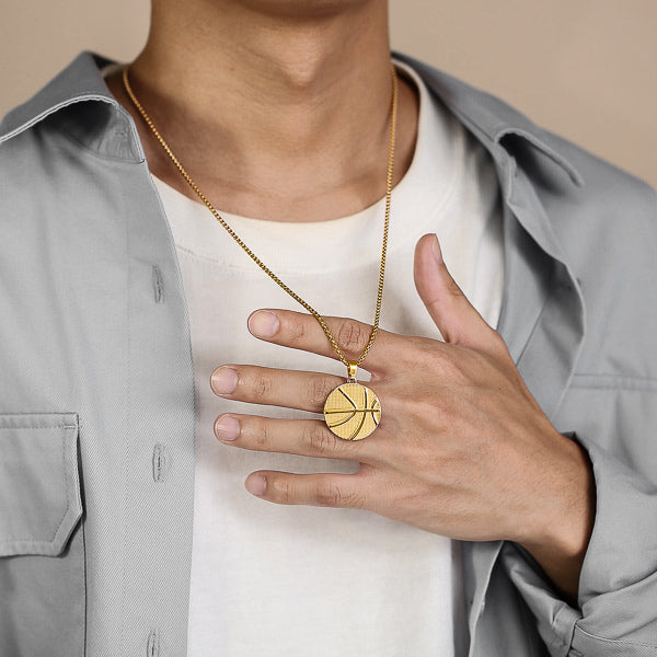 Man wearing a gold basketball pendant necklace