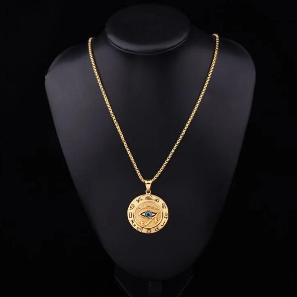 Round gold Eye of Horus pendant hanging on a stainless steel box chain
