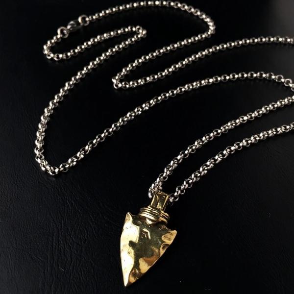 Gold spearhead pendant necklace in a detail image