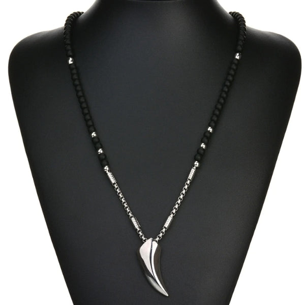 Black and silver wolf tooth necklace falls on the middle of the chest