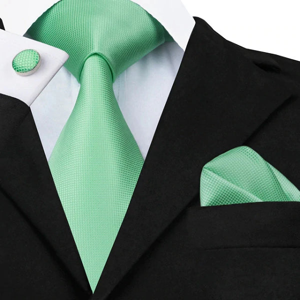 Mint green silk tie set displayed on a suit