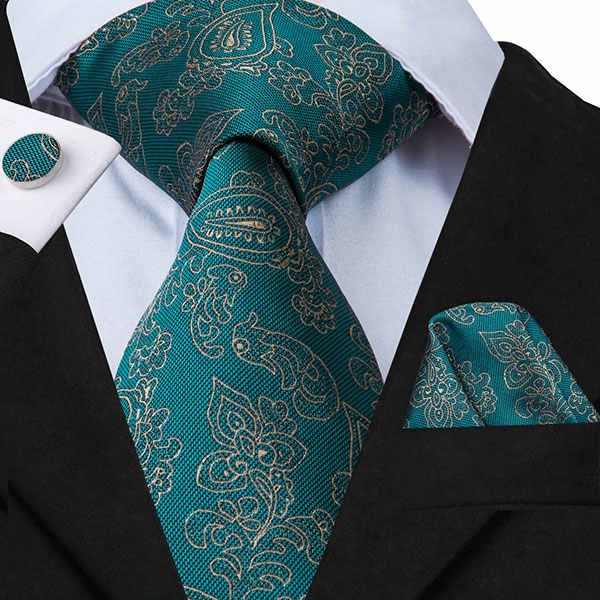 Persian green floral paisley silk tie set displayed on a suit