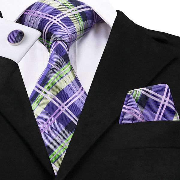 Man wearing a violet and green tartan check silk tie set with matching pocket square and cufflinks