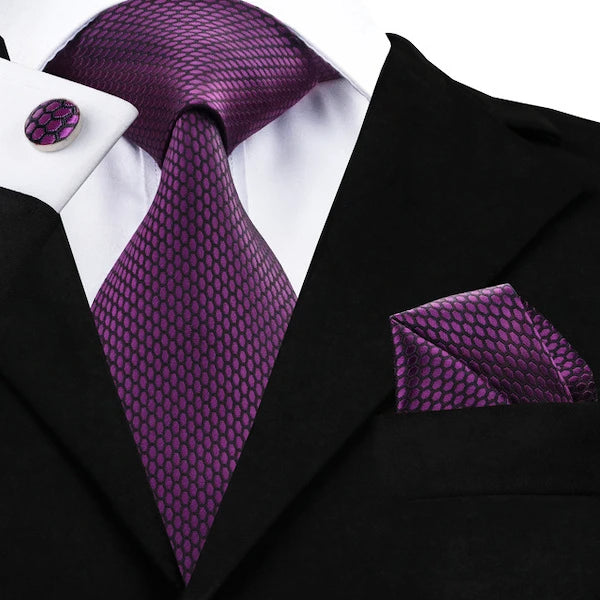 Man wearing a purple honeycomb silk tie set with matching pocket square and cufflinks