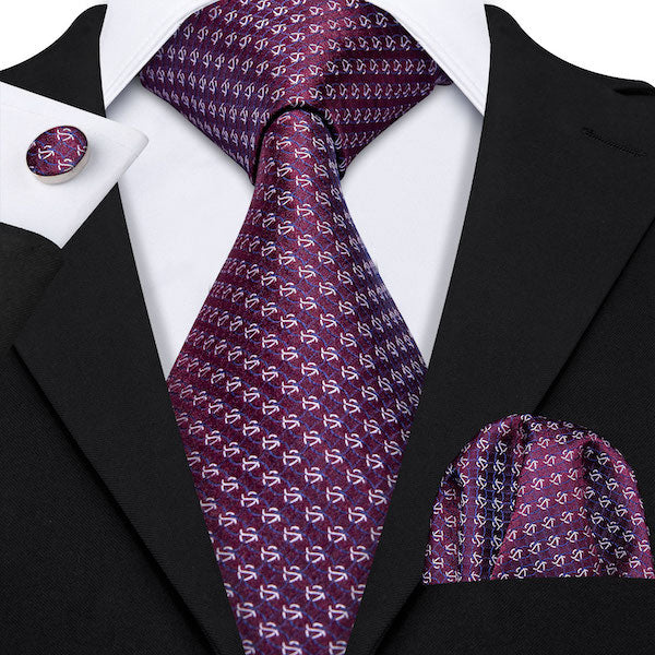 Man wearing a purple silk tie set with matching pocket square and cufflinks