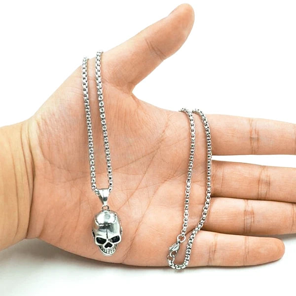 Man holding the stainless steel skull pendant necklace