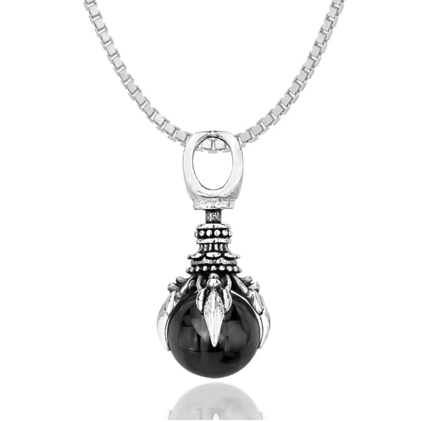 silver-toned oracle hand pendant with black crystal ball in it hanging from a chain