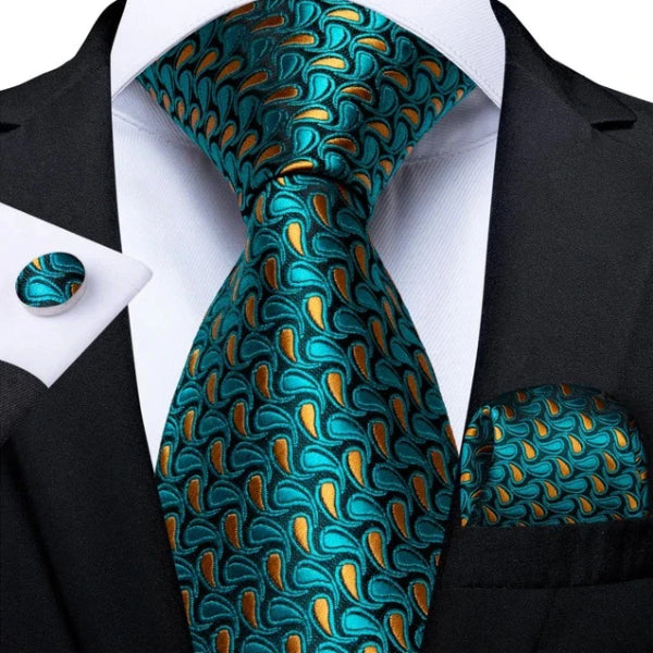Teal & gold paisley necktie, cufflinks, and pocket square set on a suit