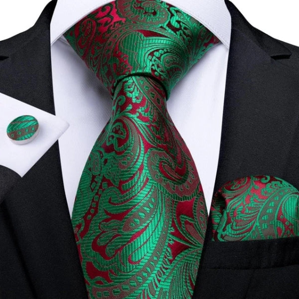 Green & red floral silk necktie set with a matching pocket square and cufflinks on a suit