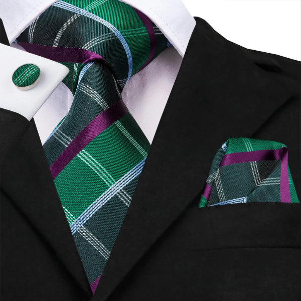 Green tartan silk tie set with a matching pocket square and cufflinks on a suit
