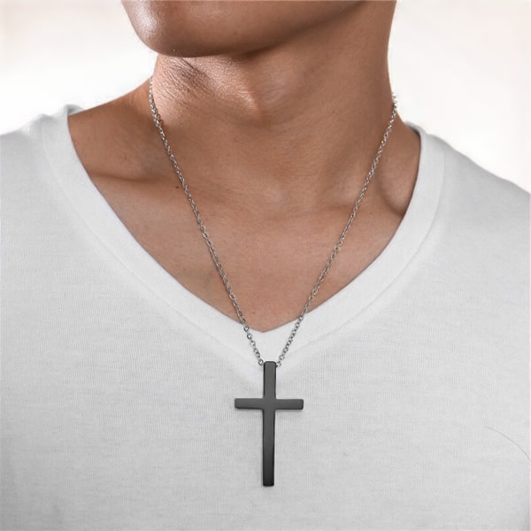 Man wearing a large black cross pendant necklace