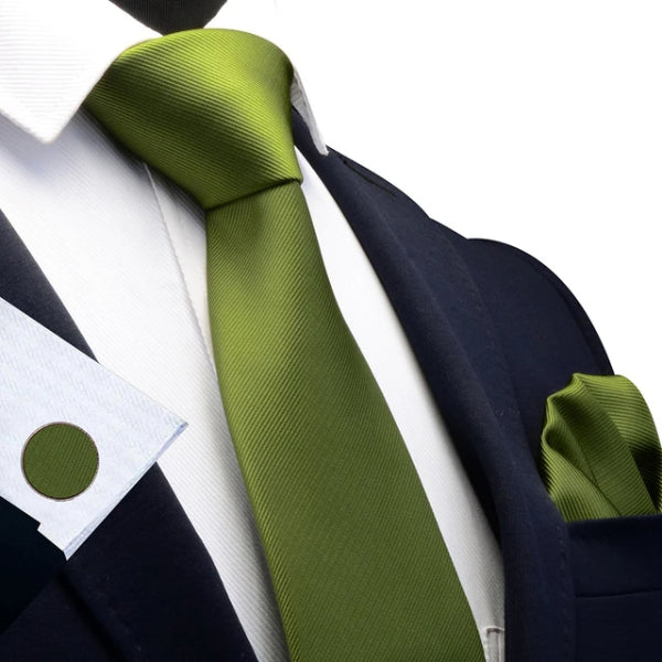 Olive green silk tie set on a suit