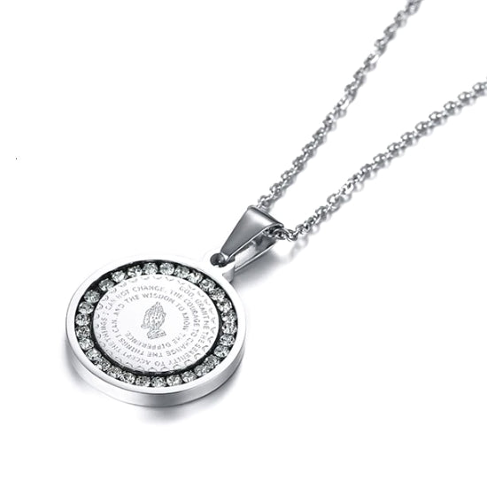 The round silver pendant has a CZ halo around the serenity prayer and an image of praying hands